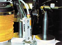 A Model 7103 Standard Ion Air Knife removes dust from computer hard disks prior to assembly.